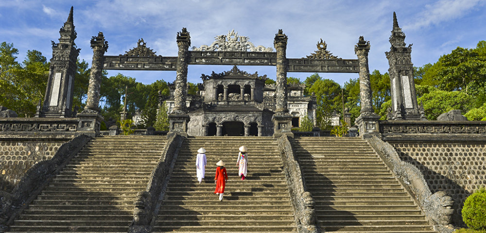 The journey begins with the Tam Quan Gate, an imposing three-arched entrance that marks the threshold to the mausoleum
